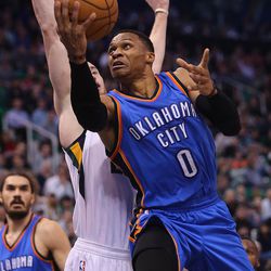 Oklahoma City Thunder guard Russell Westbrook (0) drives to the hoop and gets blocked by Utah Jazz forward Gordon Hayward (20) as the Jazz and the Thunder play at Vivint Smart Home arena in Salt Lake City on Wednesday, Dec. 14, 2016.