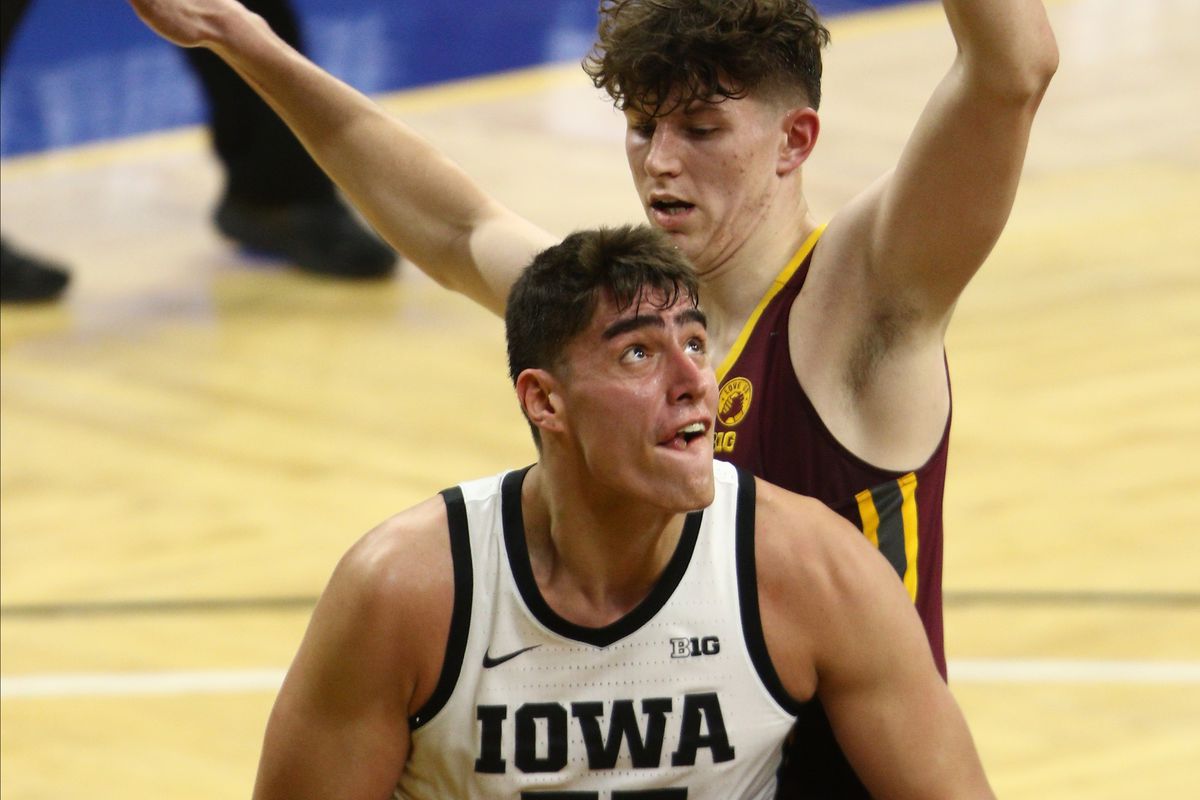 Forward Luka Garza of the Iowa Hawkeyes goes to the basket during the first half against center Liam Robbins of the Minnesota Golden Gophers at Carver-Hawkeye Arena on January 10, 2021 in Iowa City, Iowa.