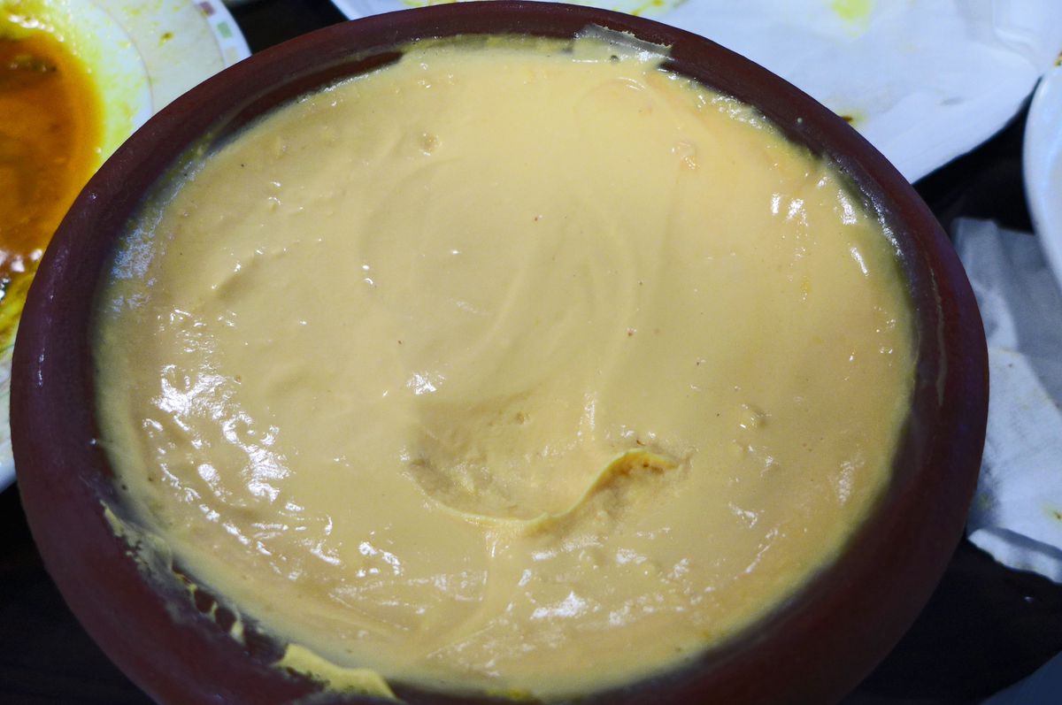 A brown bowl of brown sweetened yogurt