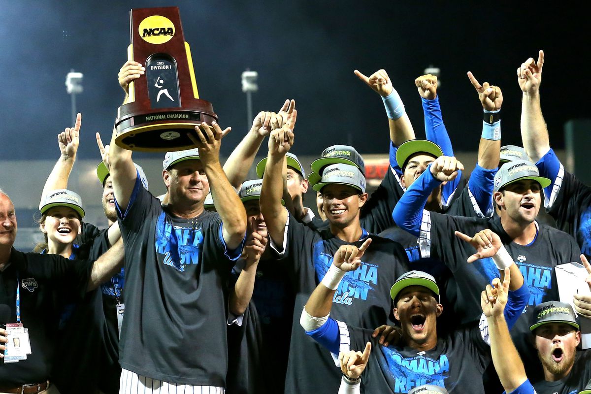 Head coach John Savage and his UCLA Bruins celebrate their 2013 College World Series title.
