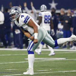 Dallas Cowboys' Dak Prescott (4) celebrates after watching Ezekiel Elliott score a touchdown on a run in the first half of an NFL football game, Monday, Dec. 26, 2016, in Arlington, Texas. 