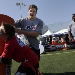 NFL draft prospects Luke Joeckel of Texas A&M, rear left, and Menelik Watson of Florida State, right, participate in a youth football clinic in New York, Wednesday, April 24, 2013. The draft begins Thursday in New York. 