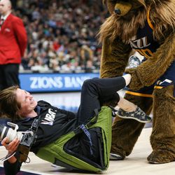 The Jazz Bear pulls NBA photographer Melissa Majchrzak off the sideline during the game against the Cleveland Cavaliers at Vivint Arena in Salt Lake City on Saturday, Dec. 30, 2017.