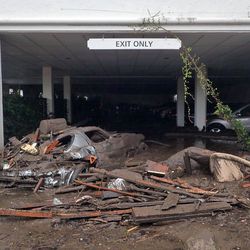This photo provided by the Santa Barbara County Fire Department shows damaged vehicles carried by mud flow and debris at the parking garage of The Montecito Inn in Montecito, Calif., Tuesday, Jan. 9, 2018. Several homes were swept away before dawn Tuesday when mud and debris roared into neighborhoods in Montecito from hillsides stripped of vegetation during the Thomas wildfire. (Mike Eliason/Santa Barbara County Fire Department via AP)