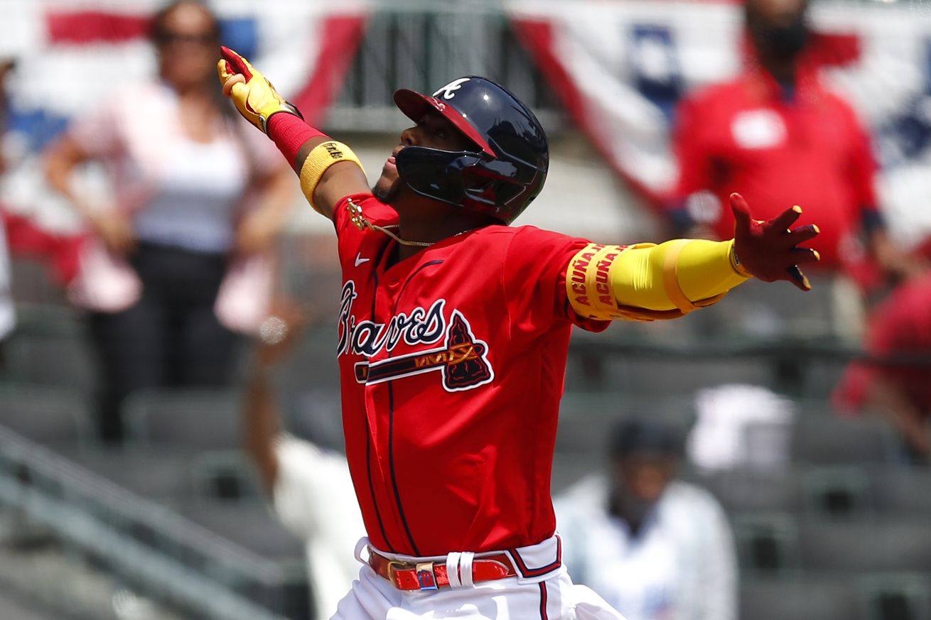 Ronald Acuna Jr jumps with joy after hitting homer.