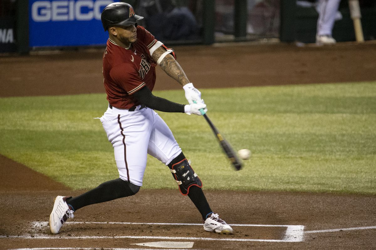 Arizona Diamondbacks player Ketel Marte (4) hits a double against the Colorado Rockies in the first inning at Chase Field.