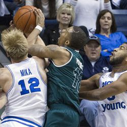 Utah Valley guard Jordan Poydras (10) secures a rebound over Brigham Young forward Eric Mika (12) during an NCAA college basketball game in Provo on Saturday, Nov. 26, 2016. Utah Valley was 18 of 37 from beyond the arc en route to a 114-101 ousting of Brigham Young.