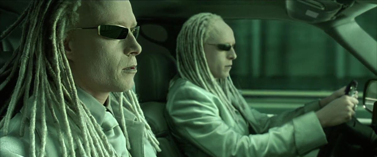 The albino dreadlocked Twins in The Matrix Reloaded driving a car