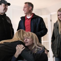 Kim Power Stilson hugs her friend, Barbara Stuart, as Mike Coyle, left, talks with Stilson's husband, Chad, and daughter, McKall, at the Stilsons' home in Orem on Saturday, Dec. 3, 2016.