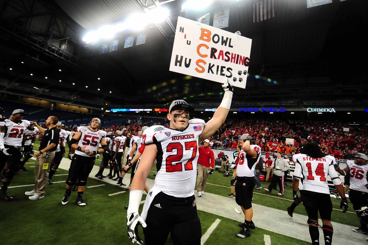 An NIU player holds a sign last year after the MAC Championship