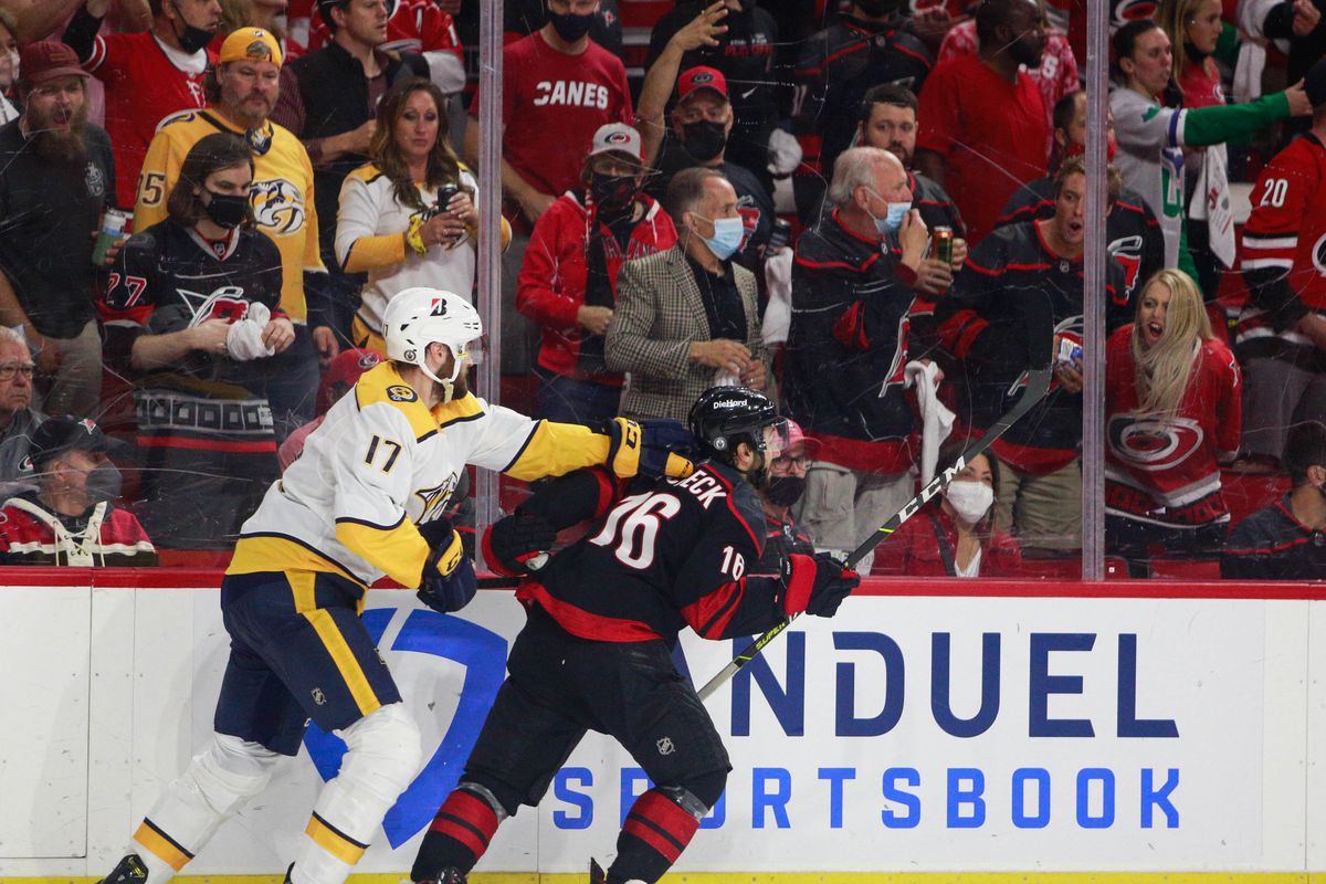 Ben Harpur #17 of the Nashville Predators pulls on the jersey of Vincent Trocheck #16 of the Carolina Hurricanes chases the puck in Game Five of the First Round of the 2021 Stanley Cup Playoffs at the PNC Arena on May 25, 2021 in Raleigh, North Carolina.