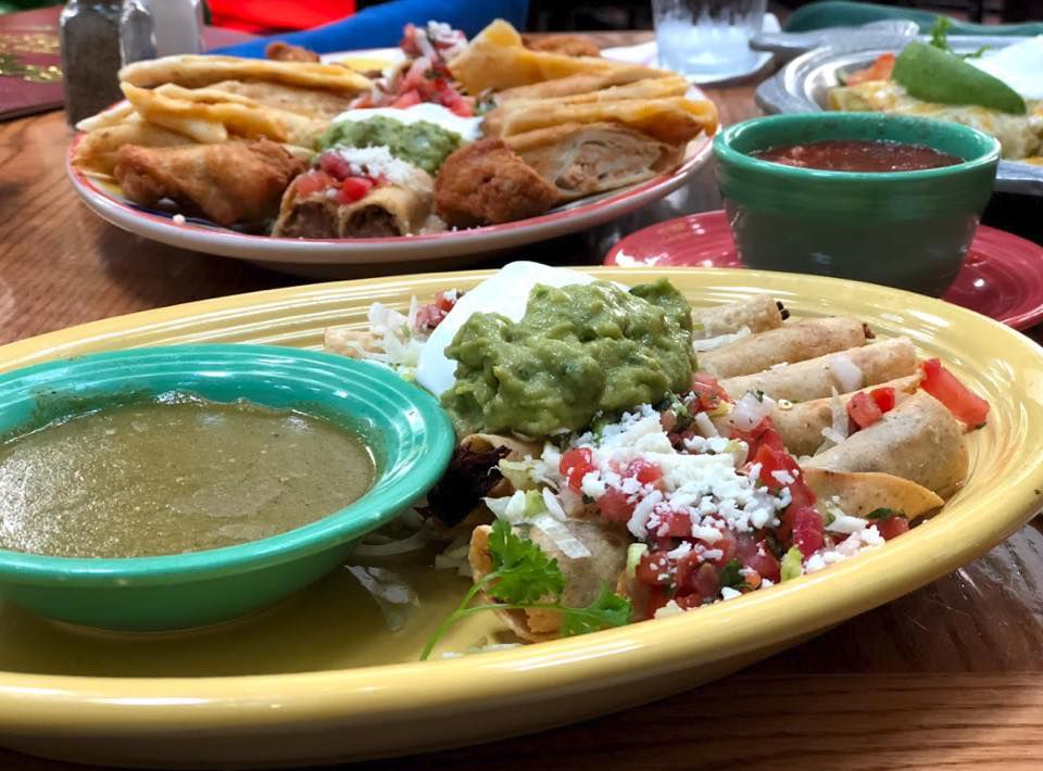 Plate containing salsa verde, tortillas and guacamole 
