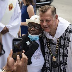Father Michael Pfleger takes a photo with a congregant after celebrating Mass for the first time since January after he was reinstated as senior pastor of the Faith Community of Saint Sabina in Auburn Gresham, Sunday, June 6, 2021. The Archdiocese of Chicago cleared Pfleger to return to the South Side church after an internal probe into decades-old allegations of sexual abuse against minors.