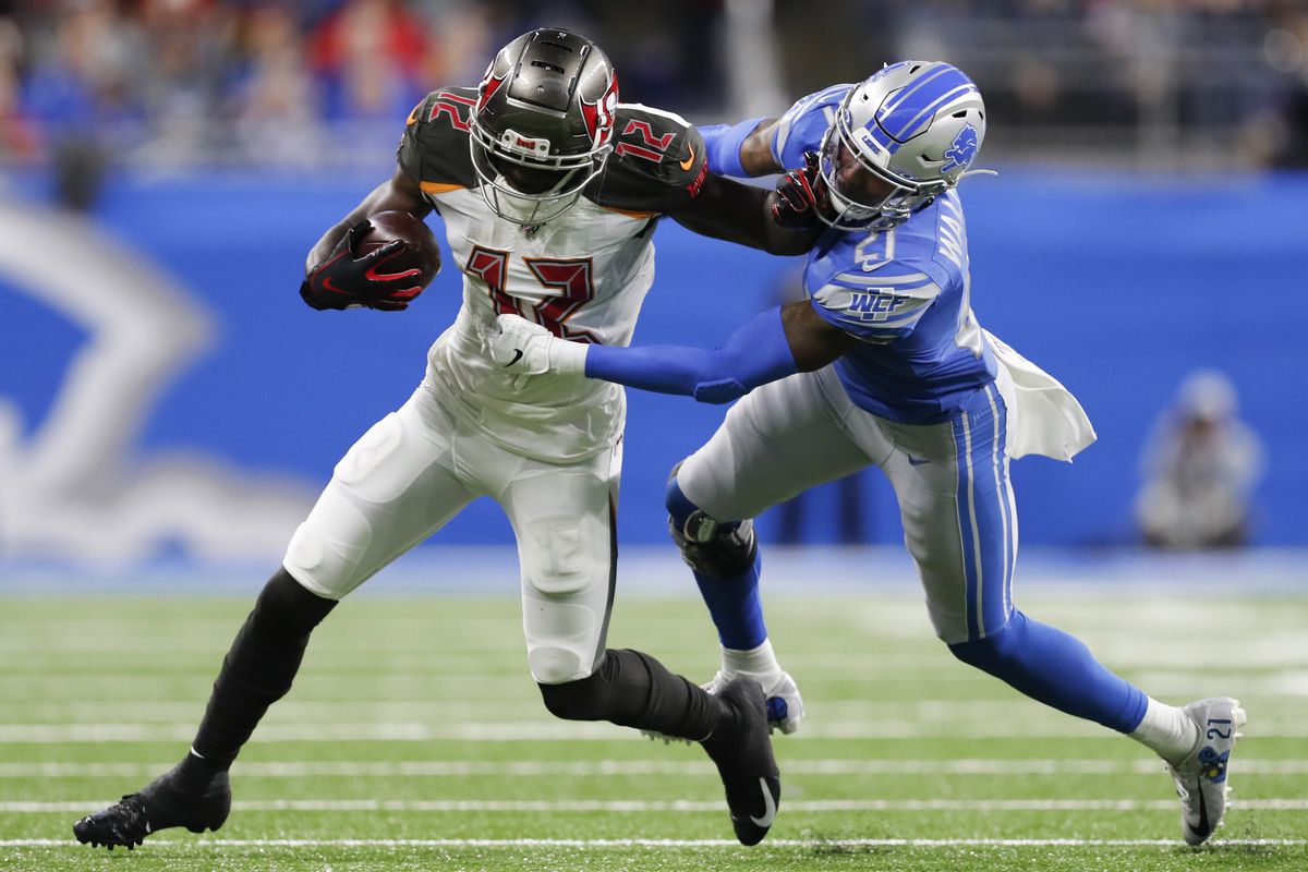 Tampa Bay Buccaneers wide receiver Chris Godwin stiff arms Detroit Lions defensive back Tracy Walker during the second quarter at Ford Field.&nbsp;