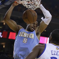 Denver Nuggets' Andre Iguodala (9) scores against Golden State Warriors' Festus Ezeli during the first half of Game 3 in a first-round NBA basketball playoff series on Friday, April 26, 2013, in Oakland, Calif. 