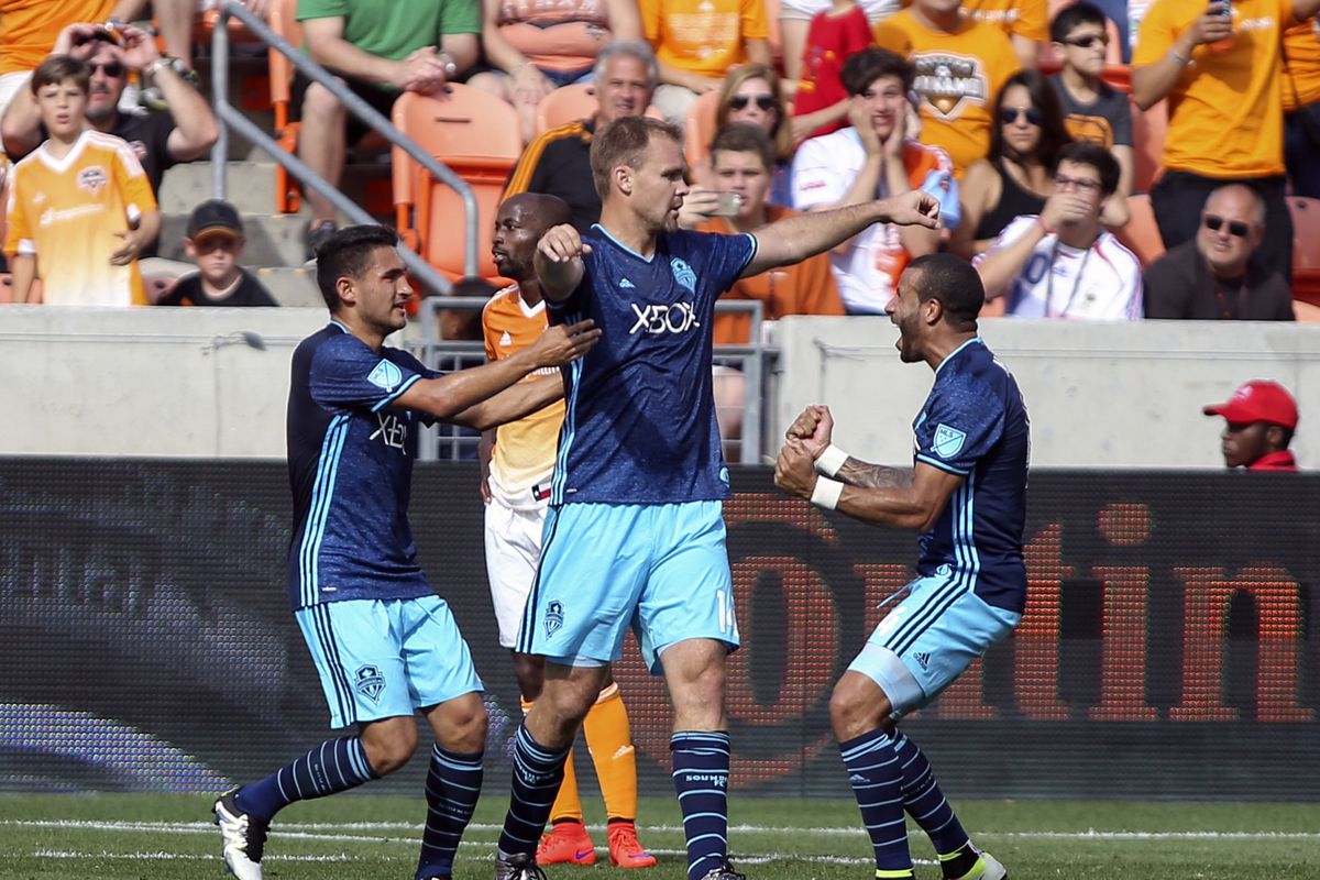 Seattle Sounders defender Chad Marshall (14) celebrates with teammates after scoring a goal in stoppage time during a game against the Houston Dynamo at BBVA Compass Stadium. The Dynamo and Sounders tied 1-1. Mandatory Credit: Troy Taormina