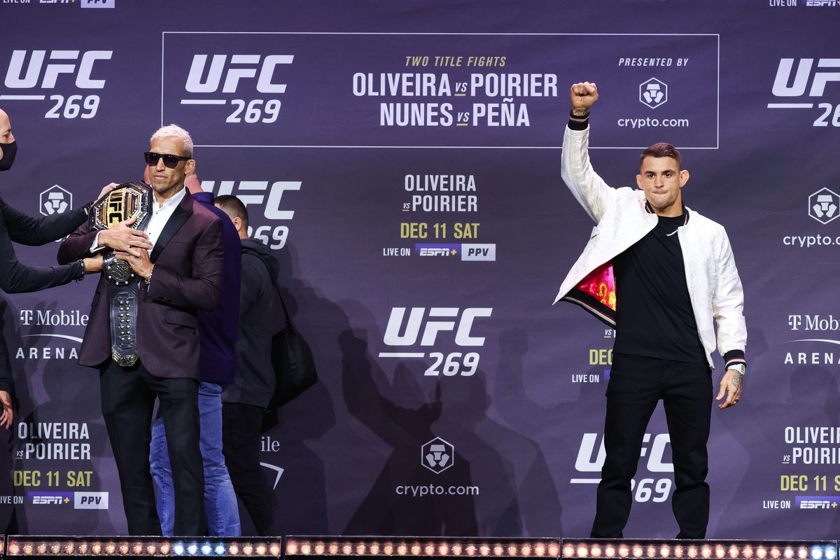  Charles Oliveira of Brazil and Dustin Poirier pose on stage during the UFC 269 press conference at MGM Grand Garden Arena on December 09, 2021 in Las Vegas, Nevada.