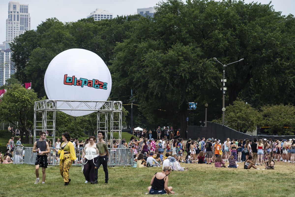Festival-goers flock to Grant Park for day one of Lollapalooza on Thursday.