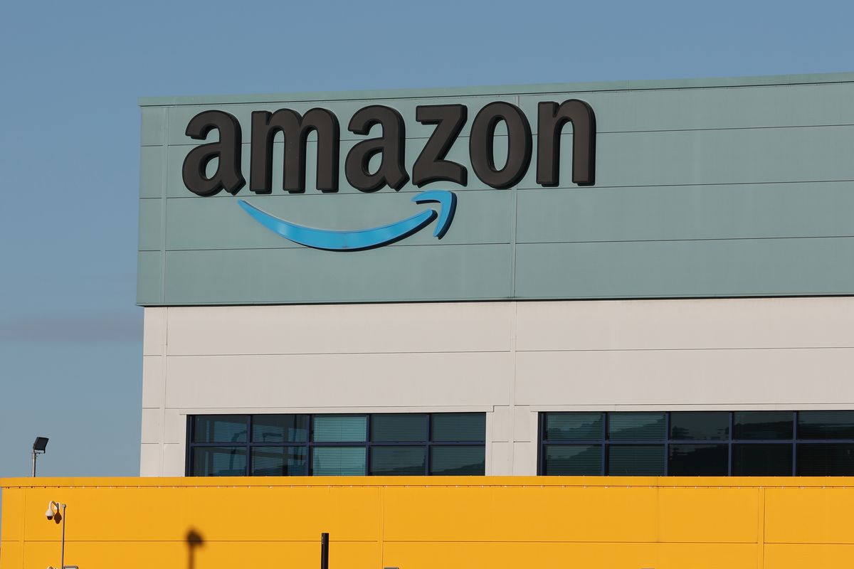 The word “amazon” and the company’s smile logo as seen on the exterior of a building.