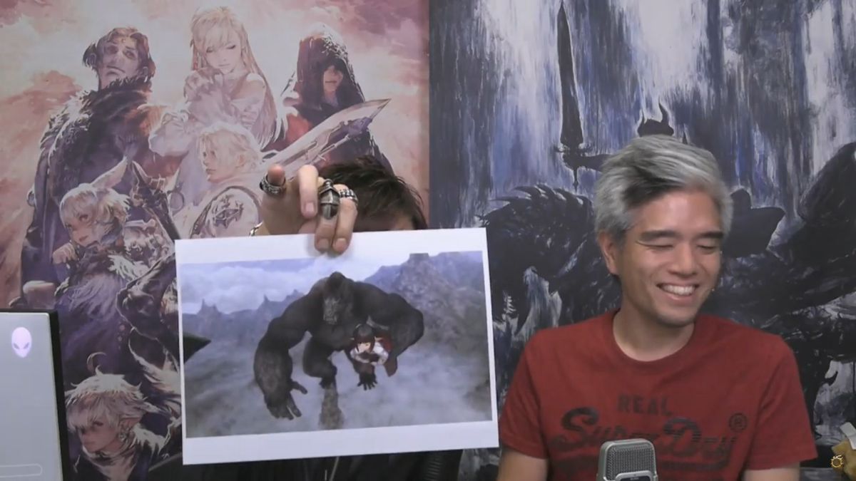 Naoki Yoshida holds up a photo of a gorilla carrying a lalafell while Toshio Murouchi laughs