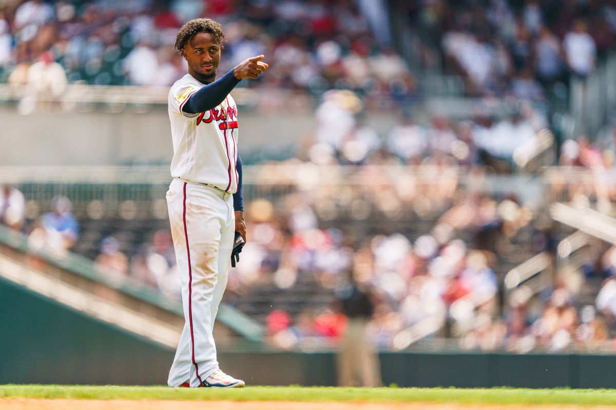 Ozzie Albies of the Atlanta Braves points in the sixth inning during the game against the Chicago White Sox at Truist Park on July 16, 2023 in Atlanta, Georgia.