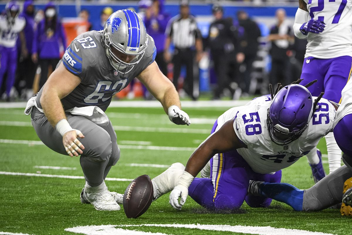 Evan Brown #63 of the Detroit Lions and Michael Pierce #58 of the Minnesota Vikings go for a fumble during the third quarter at Ford Field on December 05, 2021 in Detroit, Michigan.