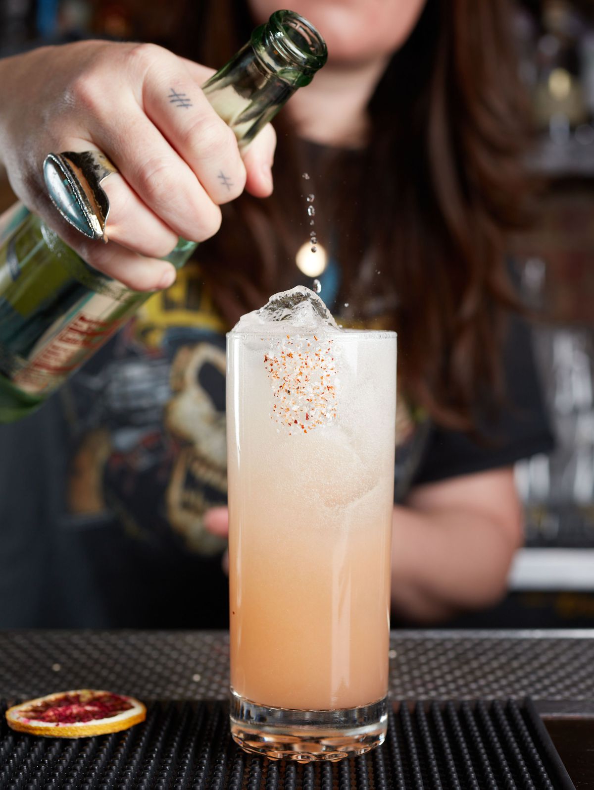 Casements co-owner Gillian Fitzgerald pours a mixed Paloma #8 drink into a glass.
