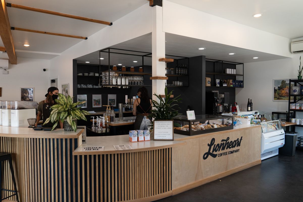 A white-and-pine-paneled coffee bar, labeled with the word Lionheart in cursive.