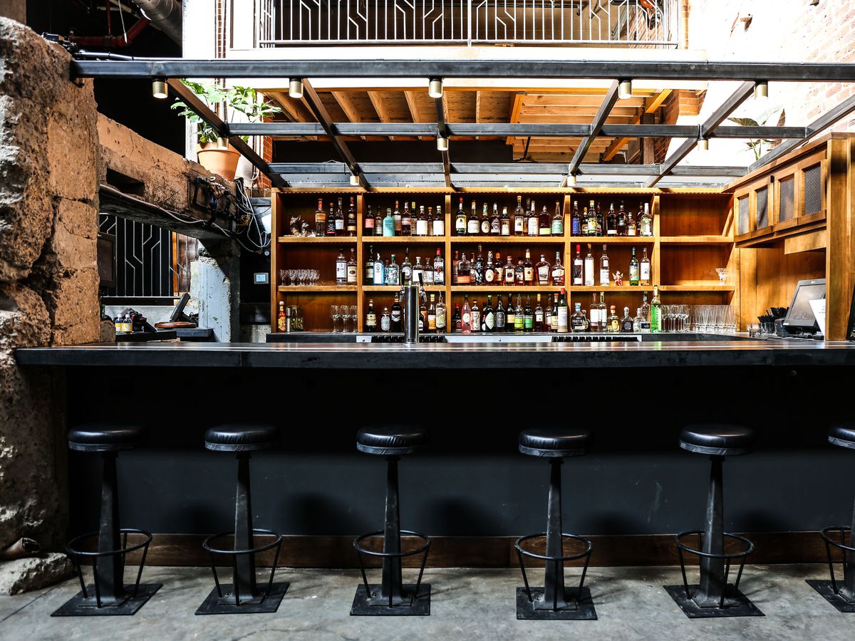 A bar with six bar stools.