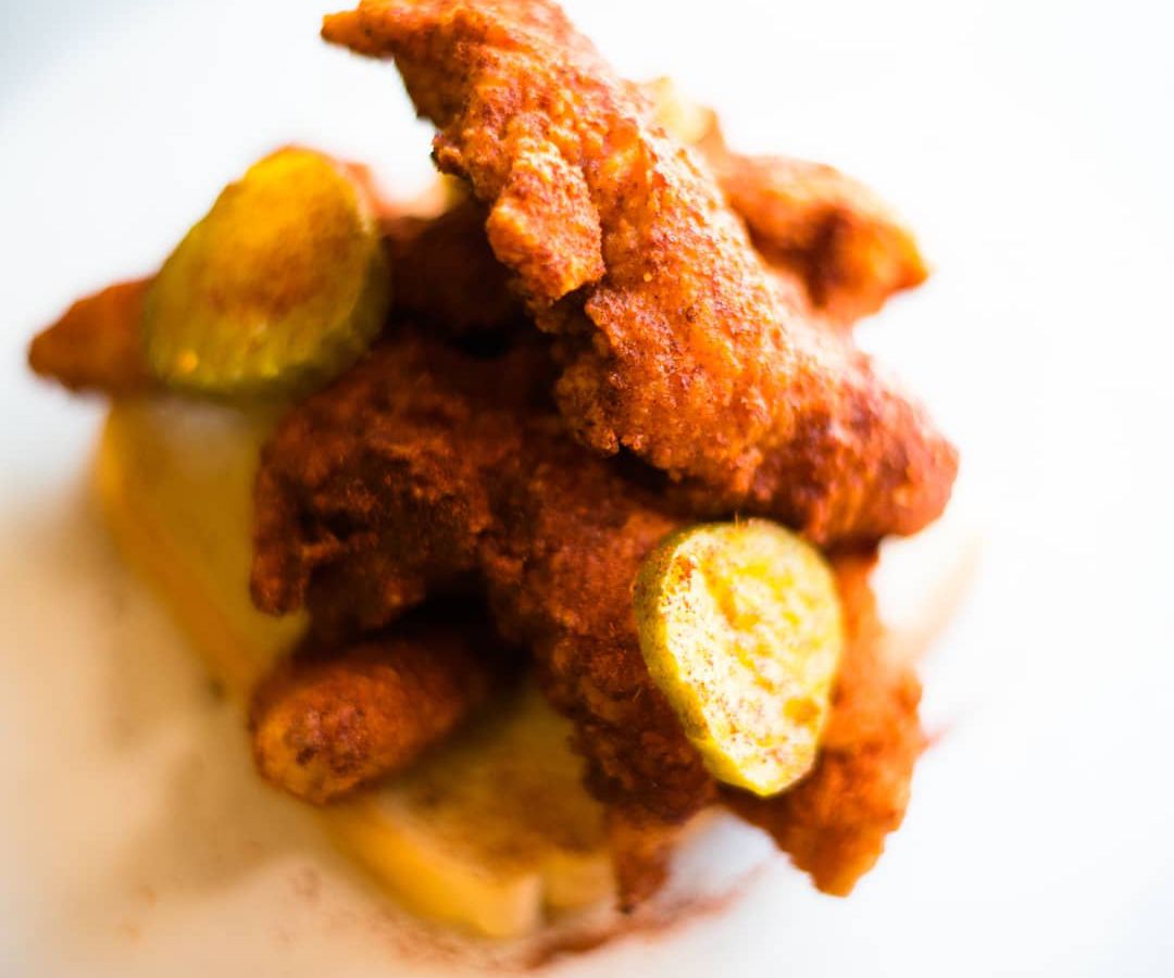 Tenders and pickles atop bread at Wooboi
