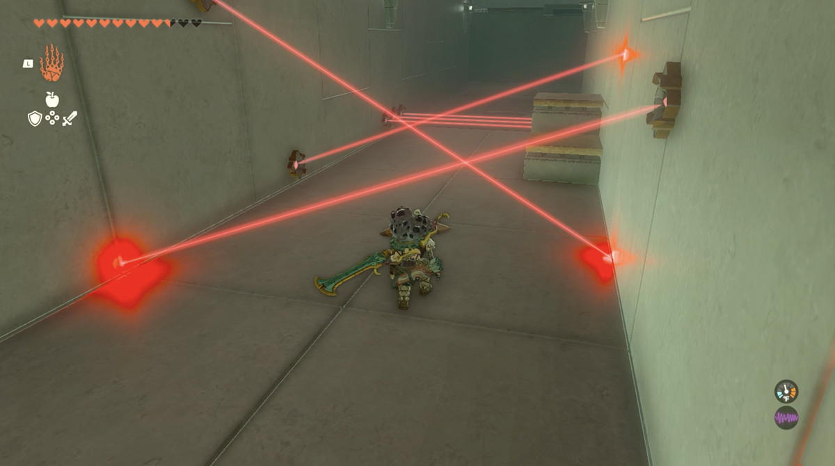 An image of a laser puzzle in Sahiro Shrine in The Legend of Zelda: Tears of the Kingdom. Link is crouching beneath res lasers pointing in different directions.