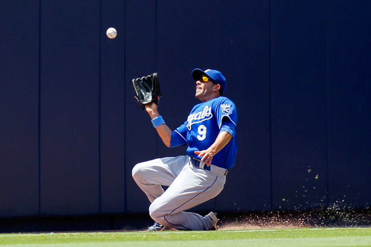 ATLANTA - JUNE 20:  David DeJesus #9 of the Kansas City Royals makes a catch as he slides into foul territory in left field against the Atlanta Braves at Turner Field on June 20, 2010 in Atlanta, Georgia.  (Photo by Kevin C. Cox/Getty Images)