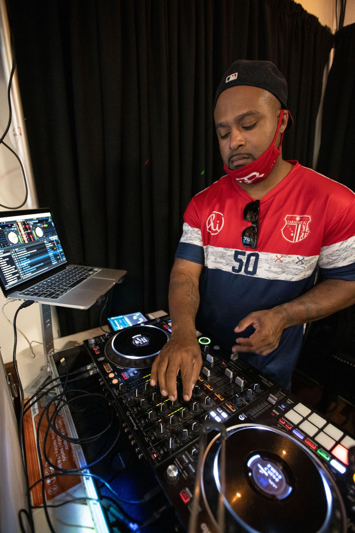A DJ spins inside a daytime sports bar.