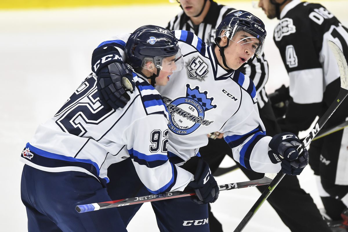Artemi Kniazev of the Chicoutimi Sagueneens celebrates his second period goal with teammate Hendrix Lapierre against the Blainville-Boisbriand Armada during the QMJHL game at Centre d'Excellence Sports Rousseau on September 28, 2018 in Boisbriand, Quebec,
