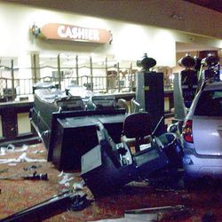 This picture provided by the Bullhead City Fire Department shows damaged slot machines after a speeding car, right, crashed through the entrance of the Edgewater Hotel & Casino Wednesday in the southern Nevada resort town of Laughlin.