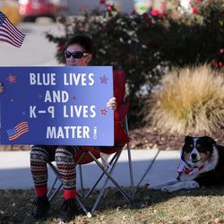 Maureen Sergent and her dog, Molly, show their support along the funeral procession route for West Valley police officer Cody Brotherson in West Valley City on Monday, Nov. 14, 2016. Brotherson, 25, was hit while trying to lay tire spikes at the intersection of 4100 South and 2200 West to help other officers stop a fleeing stolen vehicle.