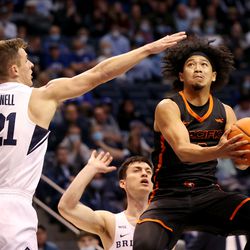 Pacific Tigers guard Pierre Crockrell II (3) flies up for a shot with Brigham Young Cougars guard Trevin Knell (21) trying to defend as BYU and Pacific play in an NCAA basketball game in Provo at the Marriott Center on Thursday, Jan. 6, 2022.