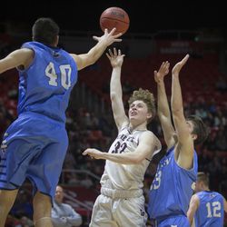 Lone Peak's Taylor Madson puts up a shot while being guarded by Layton's Collin Jeppson (40) and Brooks Kokkola (33) during the Lone Peak Knights' 82-47 victory against the Layton Lancers in the Class 6A state semifinals at the Jon M. Huntsman Center in Salt Lake City on Friday, March 2, 2018.