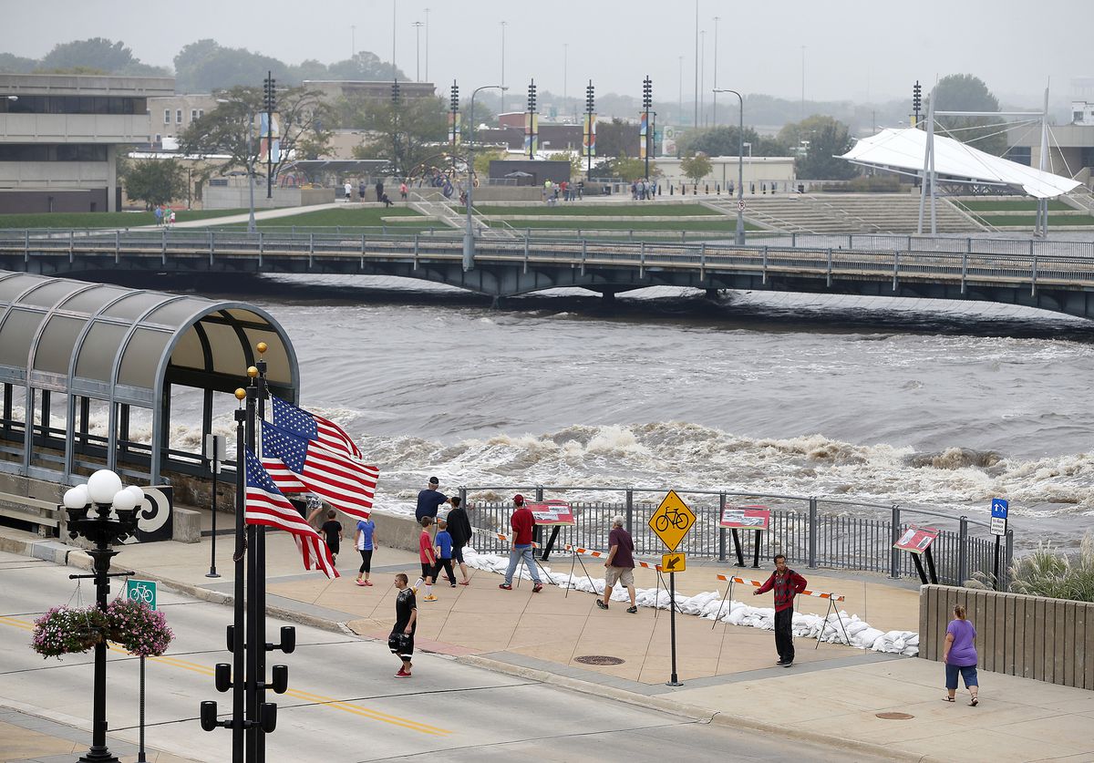 People view the flooding on the Cedar River in downtown Waterloo, Iowa, on Saturday, Sept. 24, 2016. |Brandon Pollock/The Courier via AP