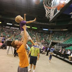 Braydon Carter helps his cousin Trey Bess shoot a free throw as Utah Jazz fans attend the team's 2013 NBA draft party at EnergySolutions Arena on Thursday, June 27, 2013.