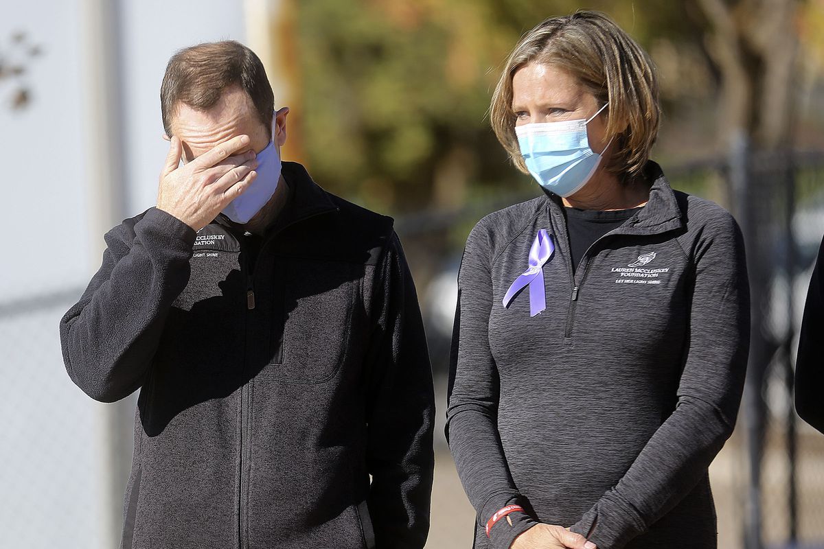 Matt McCluskey, left, wipes his eyes as he and his wife, Jill, listen to a speaker on the two-year anniversary of their daughter Lauren McCluskey’s death at the McCarthey Family Track and Field Complex in Salt Lake City on Thursday, Oct. 22, 2020. Lauren McCluskey, a track athlete, was was shot and killed on campus near her dorm by Melvin Shawn Rowland, 37, after weeks of being stalked and harassed by Rowland.