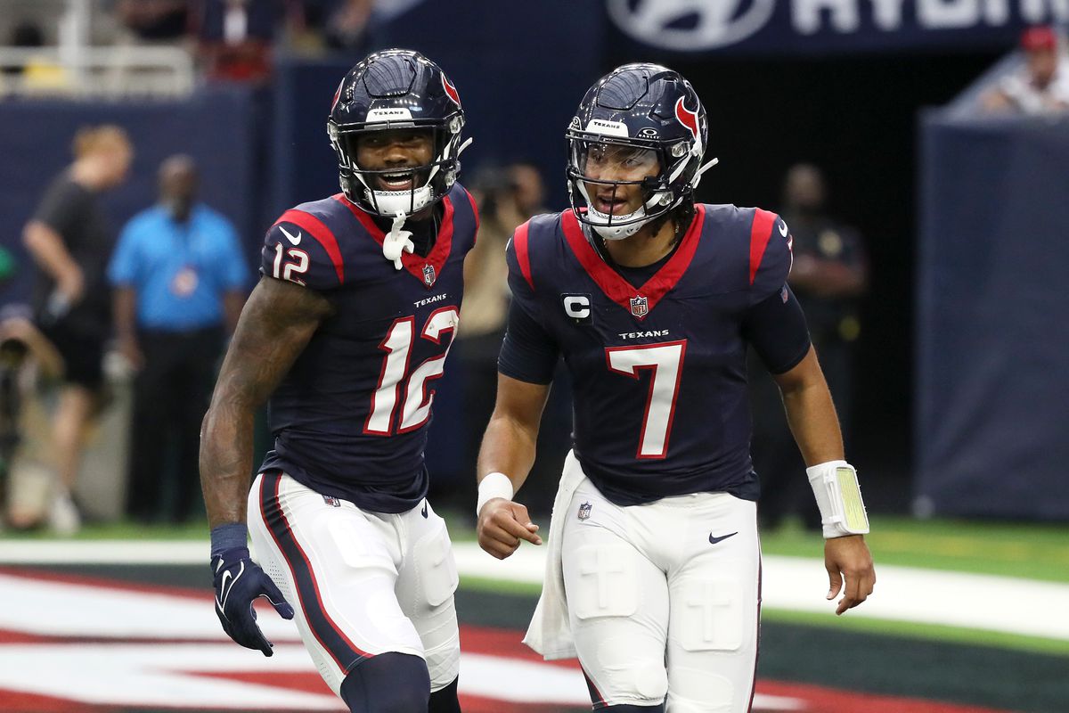 Nico Collins of the Houston Texans and C.J. Stroud react after a touchdown in the first quarter of a game against the Tampa Bay Buccaneers at NRG Stadium on November 05, 2023 in Houston, Texas.