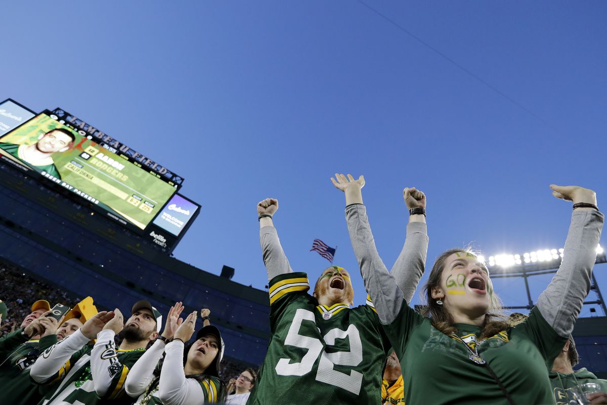 Green Bay Packers fans cheer for Aaron Rodgers as he is announced against the Chicago Bears at Lambeau Field.