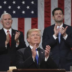 President Donald Trump pauses as he gives his first State of the Union address in the House chamber of the U.S. Capitol to a joint session of Congress Tuesday, Jan. 30, 2018 in Washington, as Vice President Mike Pence and House Speaker Paul Ryan applaud. (Win McNamee/Pool via AP)