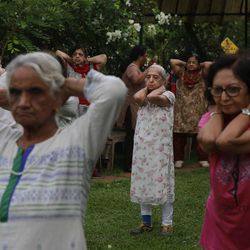 In this Tuesday June 9, 2015, photo, elderly people perform early morning yoga in a park in Mumbai, India. Yoga has a long history India, reaching back for thousands of years. Ancient temples show long-dead royalty in yoga poses. There are no reliable estimates of how many people regularly practice yoga in India, though the number is certainly in the millions. 