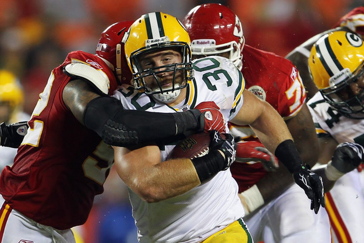 KANSAS CITY MO - SEPTEMBER 02:  Fullback John Kuhn #30 of the Green Bay Packers carries the ball during the game against the Kansas City Chiefs on September 2 2010 at Arrowhead Stadium in Kansas City Missouri.  (Photo by Jamie Squire/Getty Images)