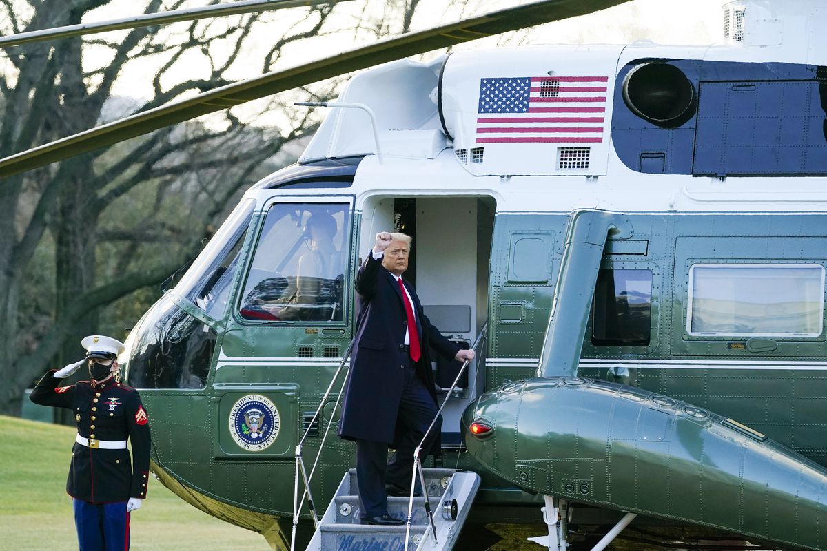 President Donald Trump gestures as he boards Marine One on the South Lawn of the White House, January 20, 2021, in Washington, DC. 