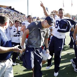 BYU head coach Bronco Mendenhall celebrates with his team after defeating Tulsa 24-21 on Friday.  