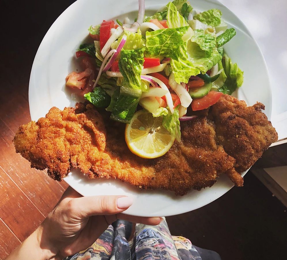 Fried schnitzel with a salad on the side.