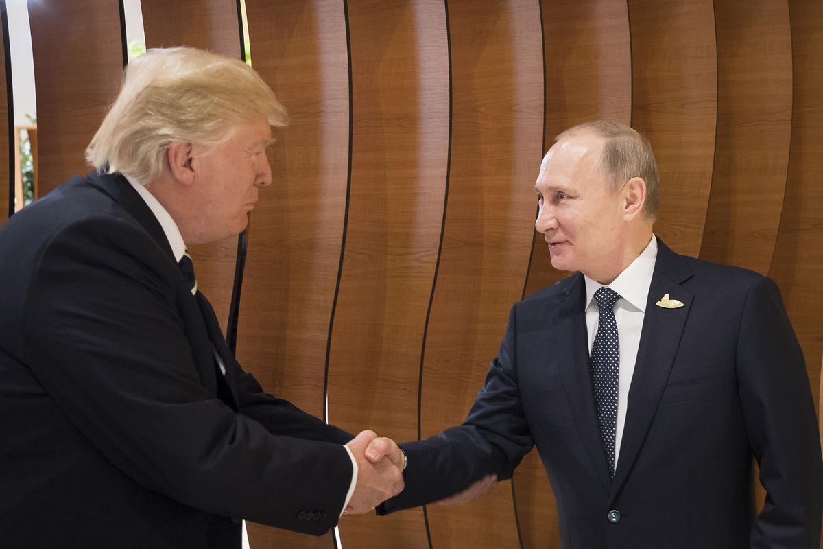 U.S. President Donald Turmp shakes hands with Russian President Vladimir Putin.